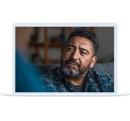 A middle-aged man reflects deeply while talking with a therapist, illustrating individual therapy in progress.