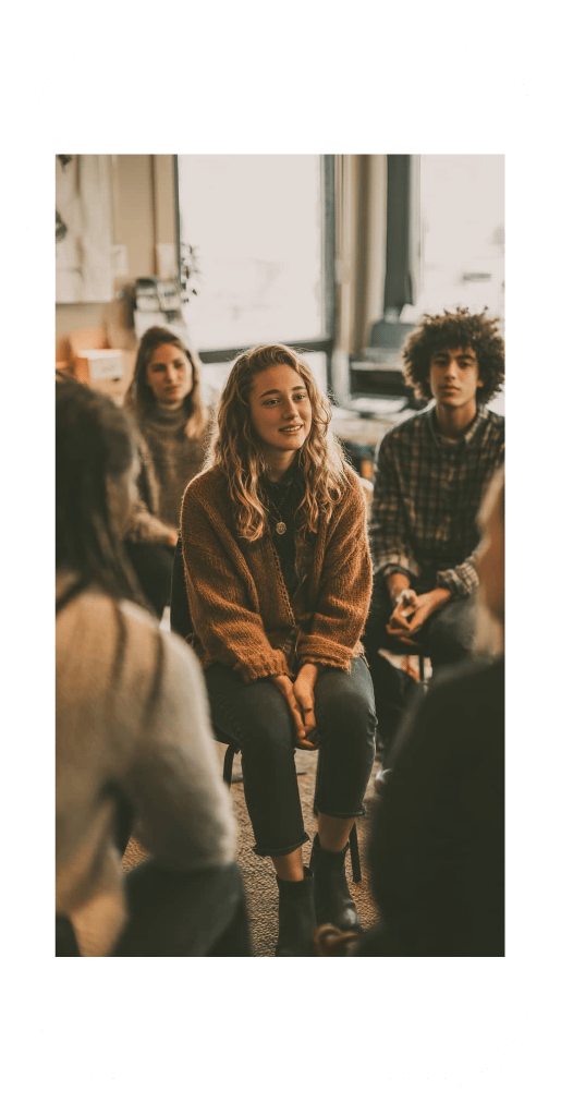 A small group of people in a therapy session, highlighting connection and support in online drug addiction treatment.