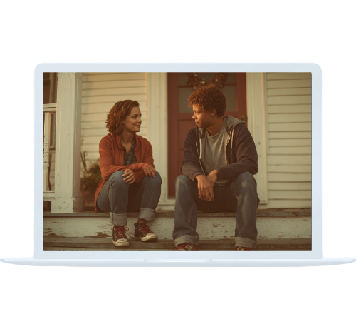 A mother and teenage son talking on the porch, displayed on a laptop screen, representing real conversations supported by online family therapy.